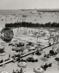 Sunbathers on the beach at the Pacific Coast Club, c. 1960