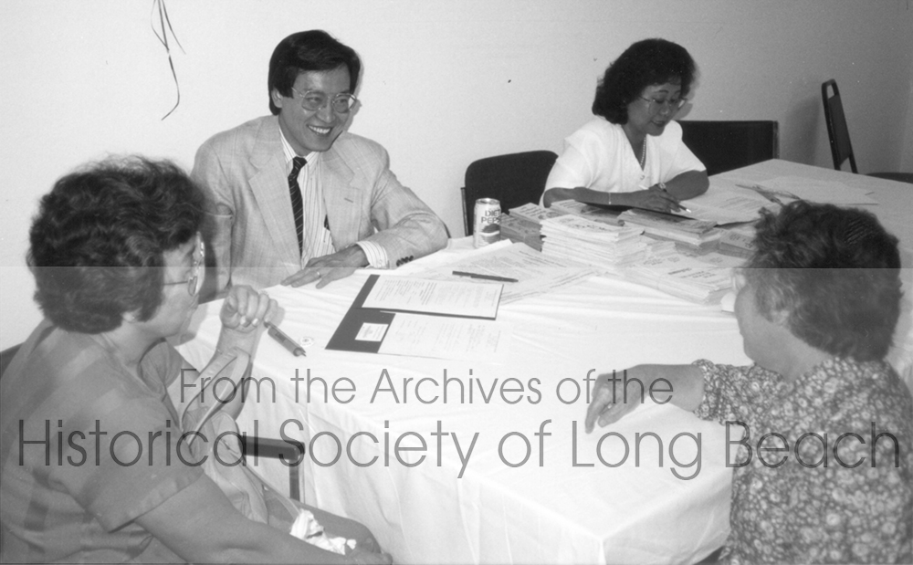 Dr. Song Tan (pictured on the left talking to elderly Cambodians) has dedicated hours of volunteer service to the community. He is photographed at a health fair sponsored by the Southeast Asian Health Project at the United Cambodian Community building in 1993.