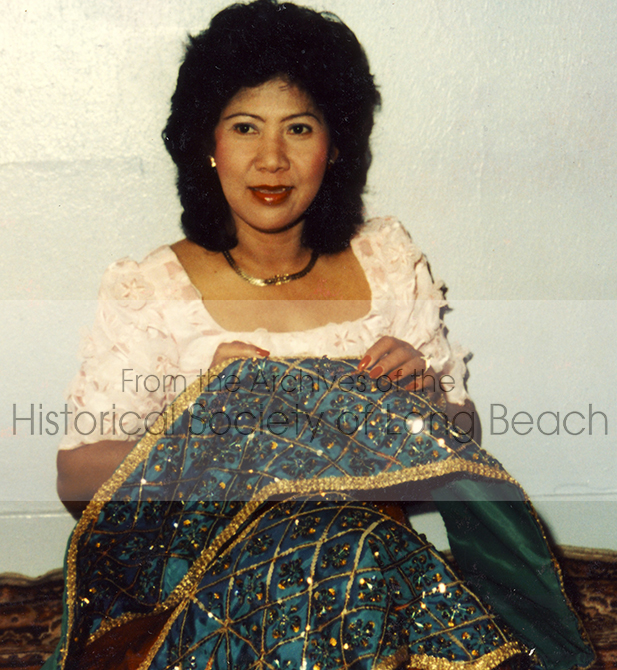 Costumes and materials from Cambodia were not available in the United States in the early days of the community. Everything had to be made by hand from memory. Leng Hang, pictured here adding beads to a shawl used in Cambodian classical court dance and weddings, had been trained as a dancer and actor while in the Cambodian Army in the 1960s. She founded the Cambodian Arts Preservation Group in 1983 in Long Beach.