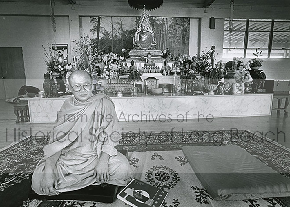 Venerable Dr. Kong Chhean seated in front of the main Buddhist altar at Wat Khemara Buddhikaram (Khmer Buddhist Temple) at 2100 Willow Street, Long Beach, CA. Date: November 27, 1988.