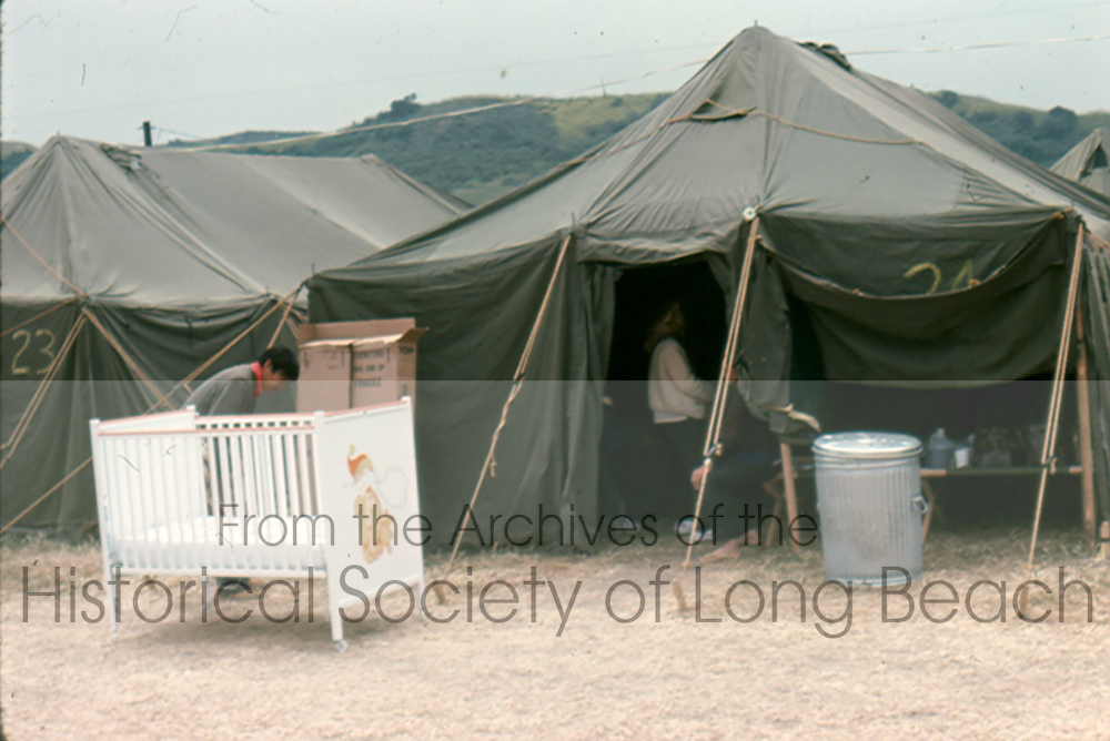 At Camp Pendleton, Marines set up makeshift tents and evacuees provided furniture and other personal items. In this image, a couple is seen setting up a crib in front of the tent. (David Kreng Collection)