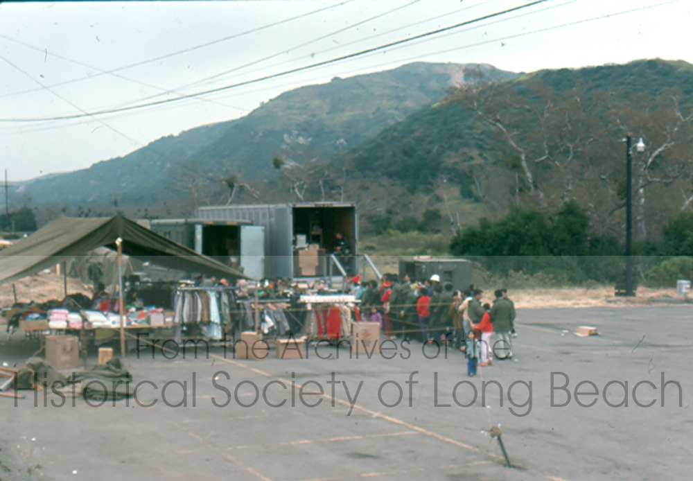 Cambodians arrived at Camp Pendleton with nothing except the clothes they were wearing. Clothing and other personal items were donated and made available to the evacuees at Camp Pendleton. Evacuees stand in line behind a truck distributing clothing and other personal items. (David Kreng Collection)