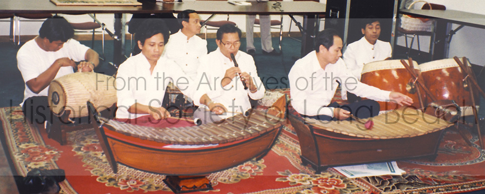 Pon Yinn (center) plays the flute alongside other pin peat musicians at a community event.