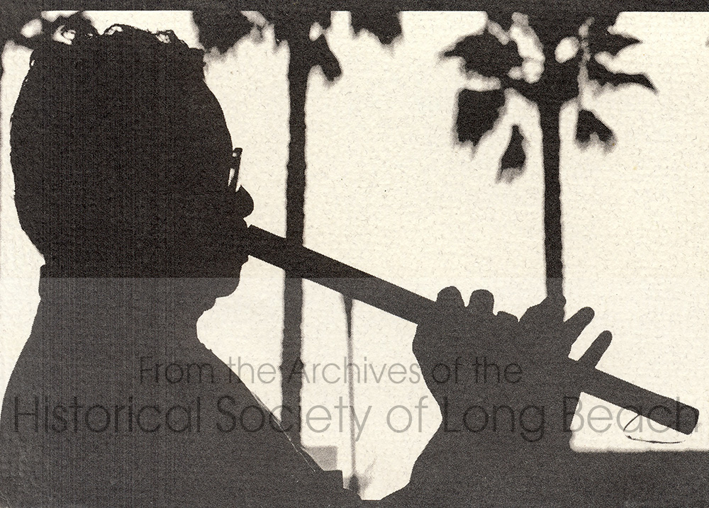Pon Yinn was featured on the front of a United Cambodian Community, Inc. holiday card, playing the flute in a side profile with palm trees in the background creating a shadowed silhouette.