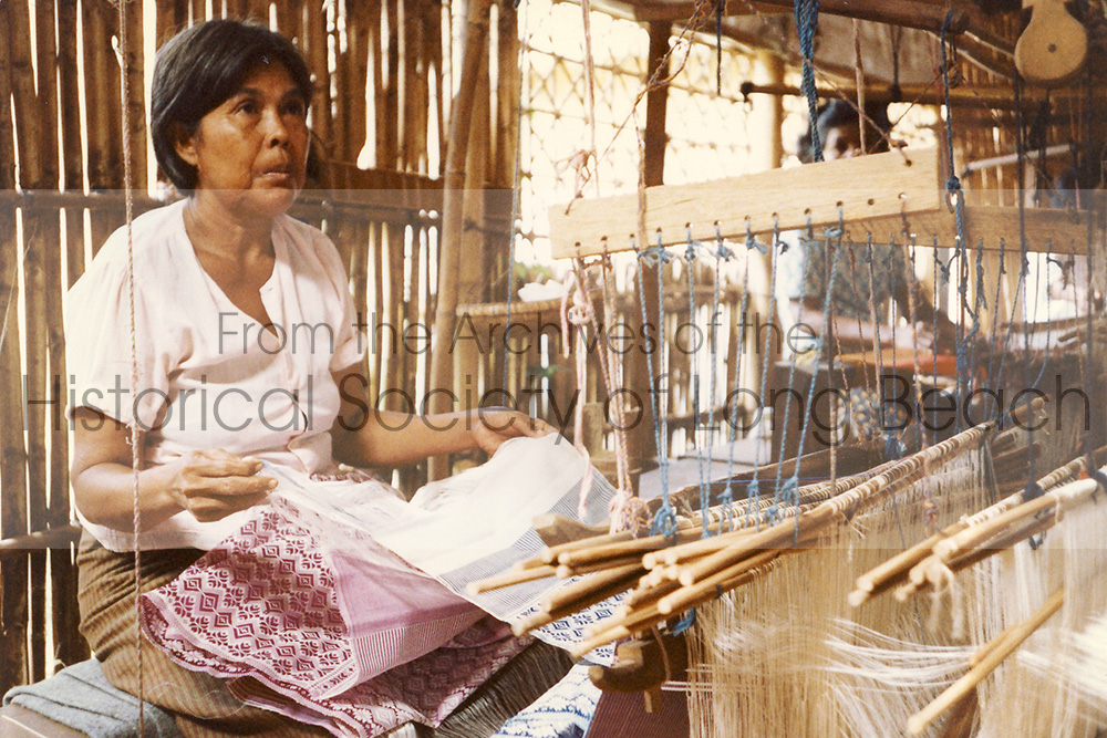 Silk production and weaving are an important part of Cambodian cultural heritage as well as a source income for many Cambodian families, especially in rural areas. Textiles are produced using various regional designs and traditional motifs for scarves (Krama), traditional clothing, and decorative fabric. In this photo, a Cambodian woman is working at the wooden weaving loom in Cambodia. (Photo courtesy of Bonnie Lowenthal)