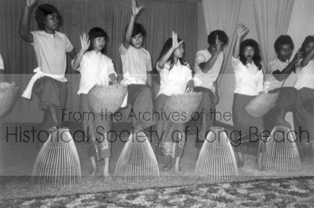 This photograph from 1982 or 1983 shows the dance troupe of the United Cambodian Community (UCC) performing a Cambodian folk dance, the “Fishing Dance.” The baskets are fish traps used in the rural areas of Cambodia. The troupe performed all over southern California.