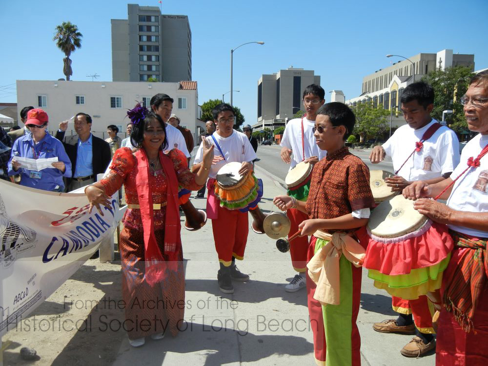 In this photo, Chhayam dancers celebrate the installation of the Cambodia Town street signs on Anaheim Street in Long Beach, California.