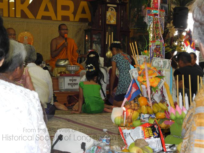 2015 Pchum Ben ceremony at Wat Willow in Long Beach, CA. Each family presents their offerings to the monks to be blessed. The merit from the offerings is transmitted to the family's ancestors through the monks. In the foreground is an offering prepared by a group of women who are following the five Buddhist precepts for a period of time. The five precepts are: do not kill, do not steal, do not engage in sexual misconduct, do not lie, and do not drink intoxicants.