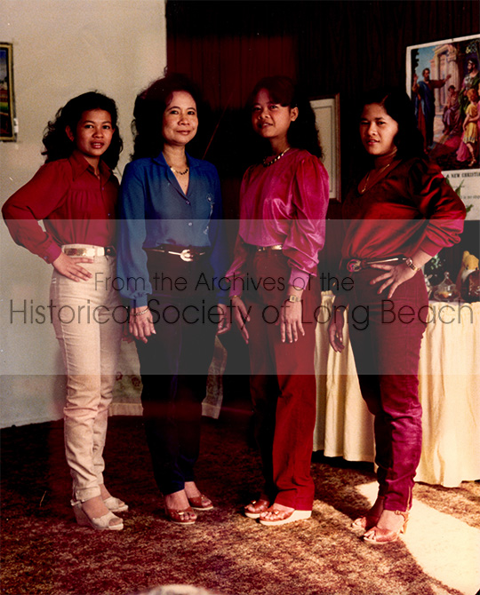 Bonavy Som’s family from left to right: her cousin, Many In; her mother, Naly Men; Bonavy Som; and her older sister, Bony Som, in Long Beach, CA. 1982. The two families shared a one bedroom apartment until they could afford a bigger place. 