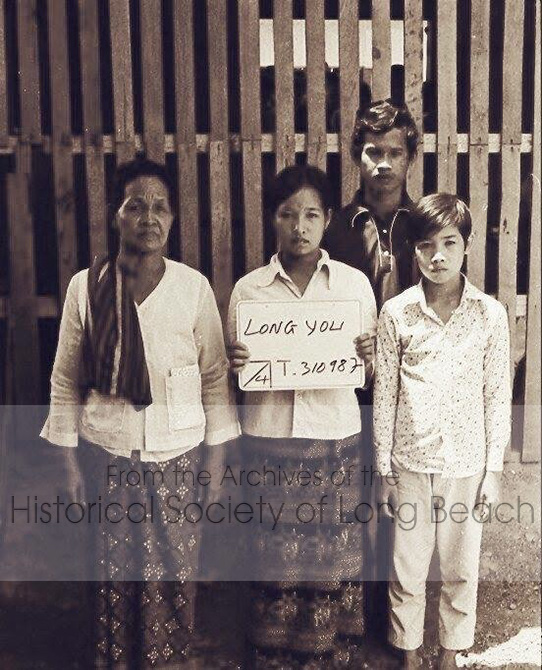 Clark Tang’s family in Chonburi, Thailand, c. 1981. From left to right are Clark’s maternal grandmother, You Long; his aunt, Pho Mak; his uncle, Chan Tha Ung; and Clark. They found a sponsor in the U.S. and were transferred from Khao-I-Dang refugee camp to Chonburi for processing. This is an official photo documenting that the family has passed the interview.