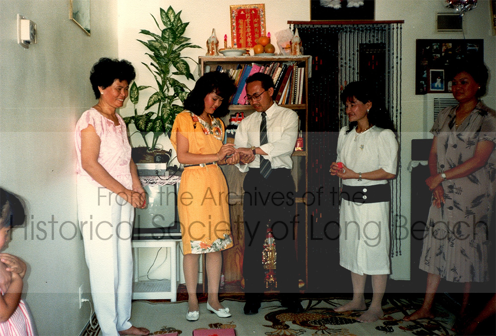 Dan Durke and Dan’s fiancée, Katherine Chao, exchanging rings at Katherine’s home in Alhambra, CA in 1989. From left to right: Katherine’s mother, Mouy Chao; Katherine Chao; Dan Durke; a distant relative, Hun; Katherine’s aunt. Dan thinks this may be when he first met Katherine’s family. Dan was in his second year of college and Katherine was finishing high school.