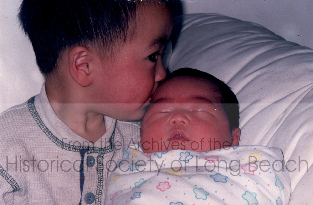 Newborn, Deanna Durke, receiving a kiss from her older brother, Dustin (about 3 yrs old), in the Durke’s new home in Gardena, CA 1996.