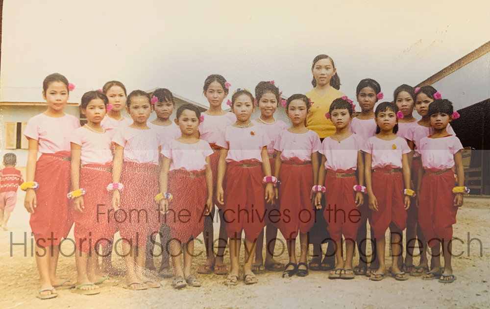 Janet Vanniroth in the dance class at Chonburi, Thailand, 1981. Janet is 5th from the left wearing a peal necklace and smiling. She is standing next to the dance teacher, in the yellow blouse. Janet recalls that most of the girls were sponsored to the U.S. but she was not able to get addresses to stay in touch. She saw the teacher once in Long Beach, CA.