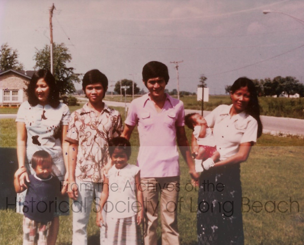 Julie Daniels and her family after arriving in the U.S. in Coal City, Illinois in 1980. Back row, left to right: unidentified woman; Julie’s brother, Logan; unidentified man; Julie’s mother, Samoth Ros, holding Janet's baby brother. Front row, left to right: brother, Todd; and Julie Daniels.