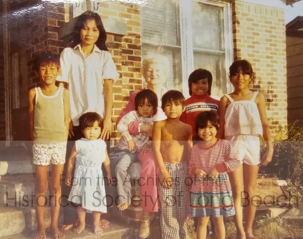Julie Daniels’ family in Fort Worth, Texas, 1984. They lived with the Sok family until they could find a rental of their own. Julie’s mother, Samoth Ros, is on the left in the white blouse, and Julie is to the far right in white top and shorts. Others in the photo are not identified.