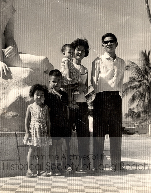 Kam Lou Lopez with her family by the ocean in Cambodia, 1965. From left to right, Kam’s older sister, Amada; her brother, William Lou; her mother, Fan Phar, holding Kam; and her father, Man Lou.