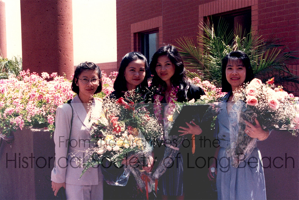 Kam Lou Lopez’s graduation from California State University Los Angeles, 1996, with a B.A. in marketing. From left to right: unidentified friend; sister, Meicy Lou; Kam; and sister-in-law, Lynh Lee.