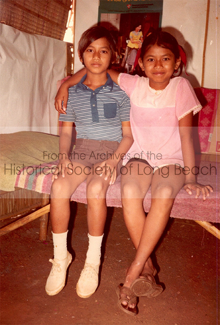 Monorom Neth (left) and his older sister, Somealy, in a makeshift bedroom in Khao-I Dang refugee camp in Thailand 1979. Note the bed is made from bamboo.