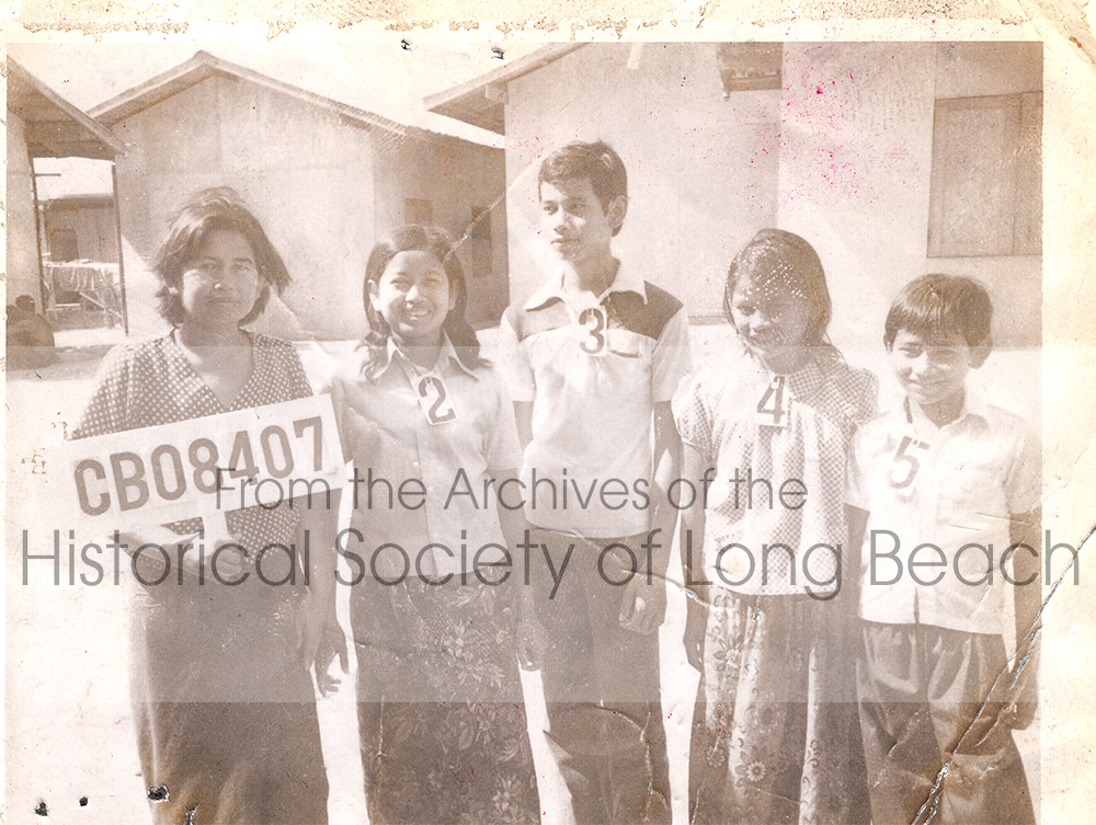 Monorom Neth’s family with their family ID number documenting they have been accepted to go to the U.S, Chonburi, Thailand 1980. From left to right: Monorom’s mother, Om Van; sister, Somealea; brother, Sakarl; sister, Somealy; and Monorom.
