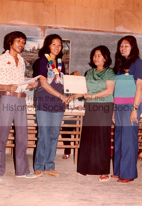 Monorom Neth’s mother, Om Van (2nd from right), receiving a certificate, at the processing center in the Philippines, 1981. Monorom is not sure why she received the certificate, but notes she is wearing her best green blouse.