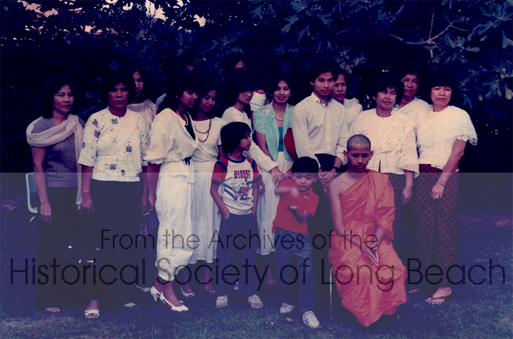 Monorom Neth (in orange robes) after completing the ordination ceremony as a novice Buddhist monk, at the Cambodian Buddhist temple in Lakewood, CA 1985. Present in the photo are Monorom’s sisters Somealy Neth (3rd from left) and Somealea (4th from left); his brother, Sakarl Neth (3rd from rt); his mother, Om Van (2nd from rt); and various cousins. The woman with the green shirt is Monorom’s oldest sister, Sovamma Neth.