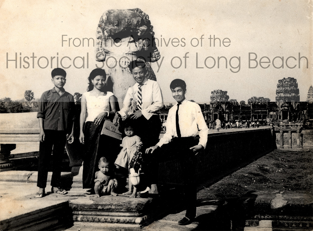 Namoch Sokhom’s family visiting Angkor Wat, Siem Reap, Cambodia, 1966. From left are Namoch’s maternal uncle (unnamed); his mother, Thach In; toddler, Namoch; his older sister, Namom Sokhom; his father, Luy Sokhom; his father’s apprentice, Kmit. Luy Sokhom was an accomplished temple architect and artist. He regularly visited temples throughout the country to study architectural features.
