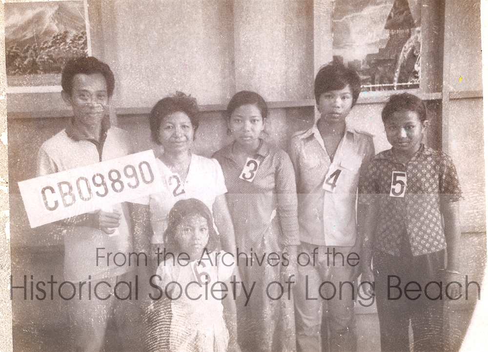 Namoch Sokhom with his family, in the Chonburi processing center, Thailand, 1981. From left, is Namoch’s father, Luy Sokhom; his mother, Thach In; his older sister, Namon Sakhom; Namoch; and younger sister, Sovathana Sokhom. In front is the youngest sister, Sophois Sokhom. After passing the interview process, they were notified they would be going to the U.S. The family was sent to Galang II Refugee Camp in Indonesia, where they attended English classes before leaving for the U.S.