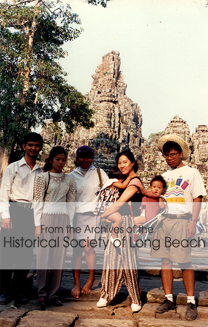 Namoch Sokhom (far right in hat) with his family and friends at Bayon temple, Siem Reap, Cambodia, 1996. From left is a Cambodian-American National Development Organization volunteer from Minnesota and his wife (both unnamed); Namoch’s sister, Sovathana; his wife Shufen holding their two children; and Namoch. Of note is the way Sufen is holding the children, with one in front and one in a carrier on her back. Cambodians criticized her because they held the babies only in front, but, according to Shufen, it was too hot to do that.