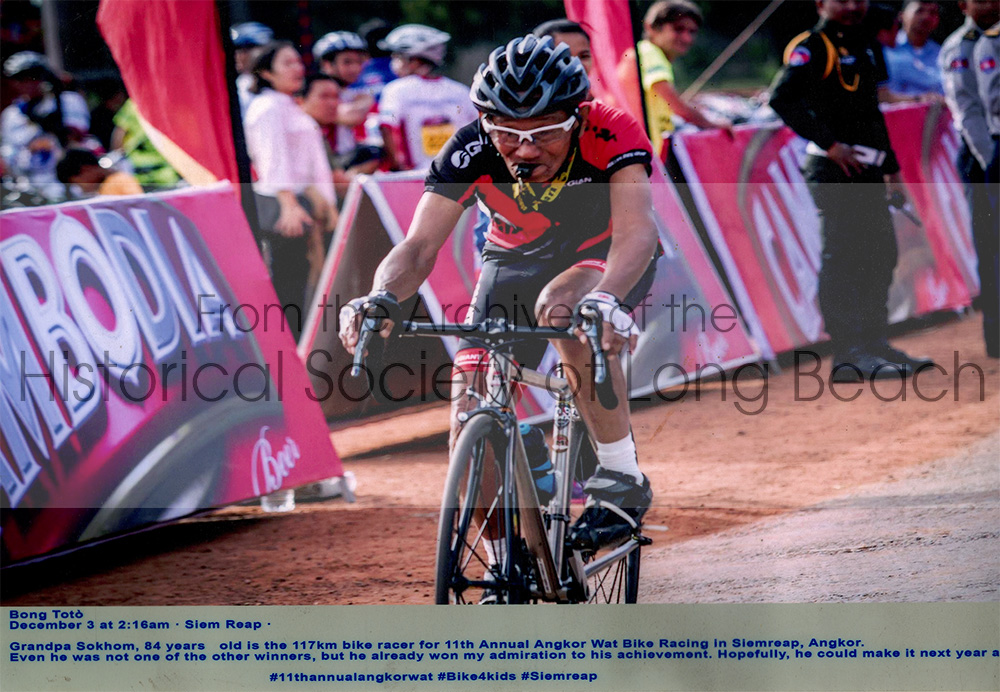 Namoch’s father, Luy Sokhom at age 84 in a 117 km race for the 11th Annual Angkor Wat Bike race in Siem Reap, Cambodia 2019. He uses the whistle to warn people to get out of the way.