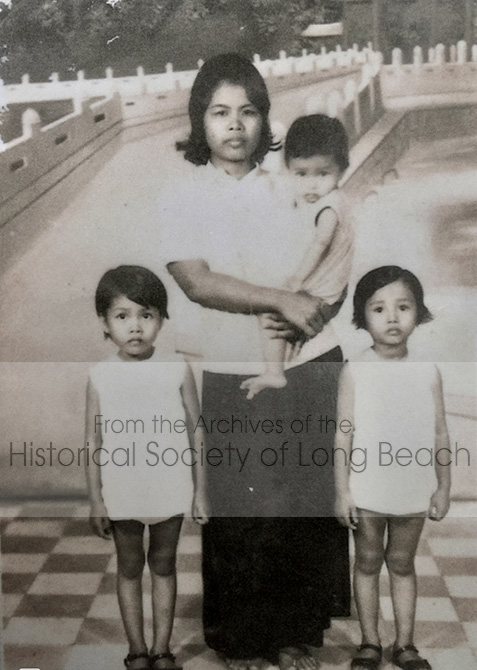 Studio portrait of Sithy Yi and her sisters taken in Phnom Penh, c. 1974 before the Khmer Rouge took control of Cambodia. The family surname prior to the Khmer Rouge was Diep, but they used Yi during the Khmer Rouge because the Diep family was marked for execution. From left to right are Sithy (5 yrs old) the family maid (unidentified), Sitheavy (2 yrs old, later changed her name to Jennifer Diep), and Sithea (4 yrs. old).