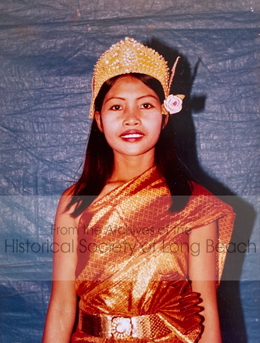 Sithy Yi at the Kampot Refugee Center, Thailand, 1981. Sithy is dressed to perform in the Wishing Dance, one of the first dances novices learn to perform. During the Khmer Rouge all forms of traditional dance and music, which were a central part of Cambodian life, were forbidden and performers were executed. It is estimated that 90% of all artists died during that time. The recreation of Cambodian music and dance was extremely important to the survivors. Music and dance troupes were formed in many of the refugee camps and children spent their days learning, practicing, and performing.
