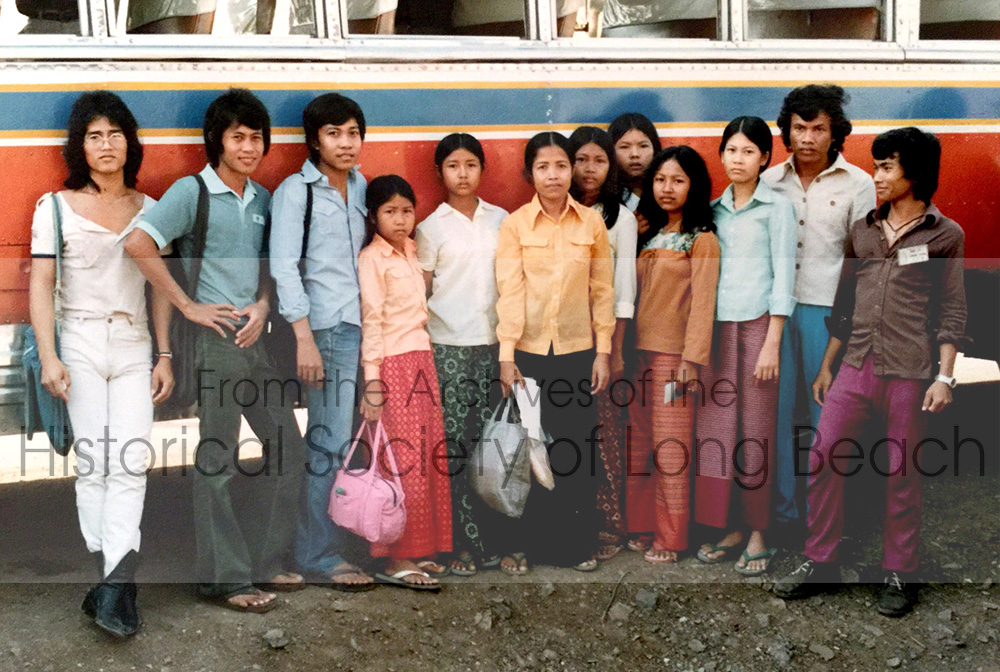 Sithy Yi and her family at the Kampot Refugee Center waiting to board the bus going to the Chonburi Refugee Center, Thailand, where they were processed for travel to the U.S. Friends came to say goodbye. From left to right are Touch (nickname); unidentified boy; Thivuth; Sithy’s sisters, Sitheavy and Sithea; Sithy’s mother, San Thi Tran; Sithy; Srey; Ravida Ma (wearing orange blouse); dancer, Mach (nickname); music teacher, Seoun; dancer, Noy.
