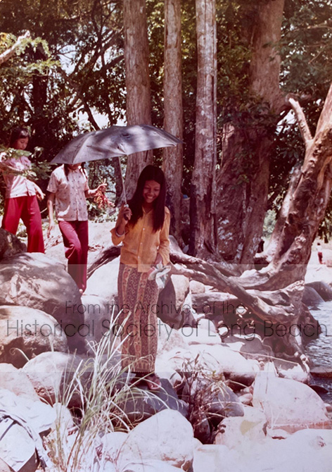Sithy Yi (front) and two unidentified friends are walking along the stream in the Bataan Refugee Processing Center in the Philippines, 1981.Sithy’s uncle, Tran Anh, who lived in Long Beach, CA. sent the family some money to buy clothes. They also hired a photographer to take pictures.