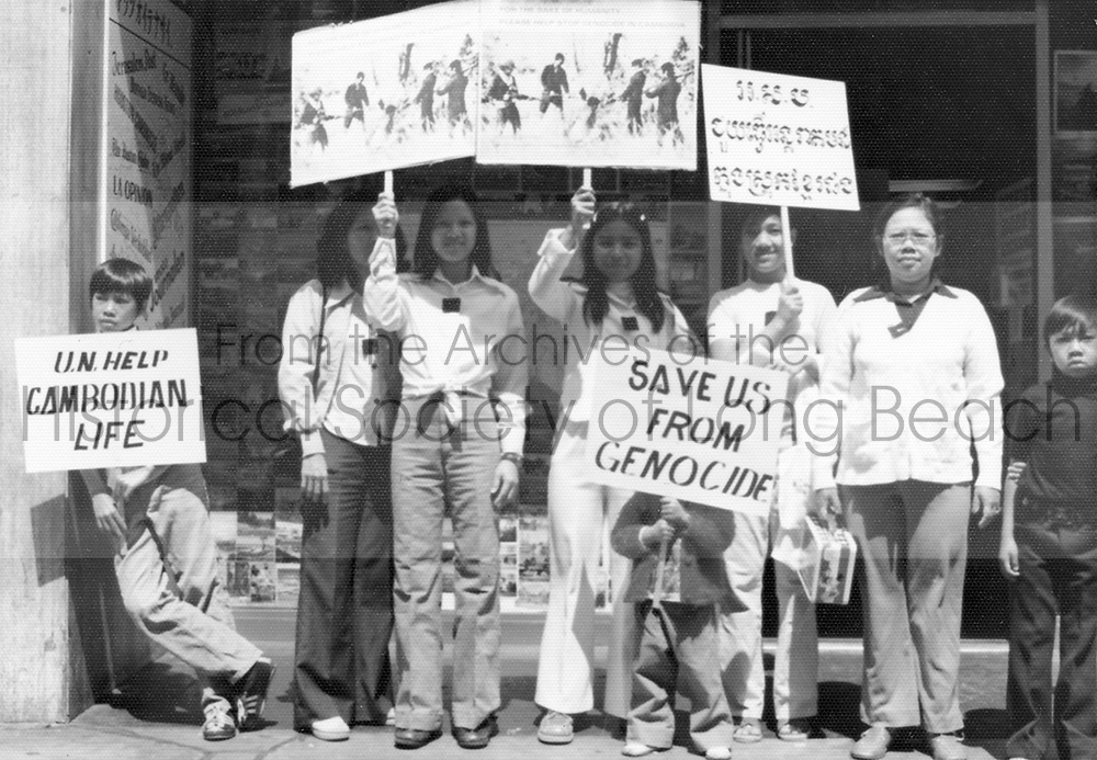 As reports from survivors of the Khmer Rouge atrocities leaked out to reporters, Cambodians from Long Beach and the surrounding area organized a protest in front of the United Nations building in downtown Los Angeles. In this photo protesters, including young children and teenagers, hold up images of Khmer Rouge committing atrocities and hold up signs that read, "SAVE US FROM GENOCIDE."(Courtesy of Cambodian Association of America.)